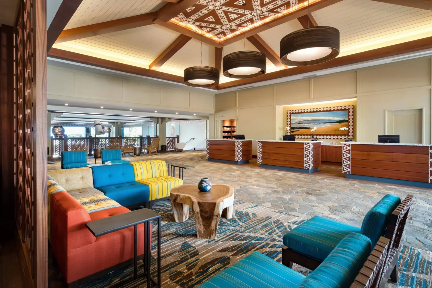 Reception desks and colorful lounge seating in the lobby at Residence Inn Maui Wailea.