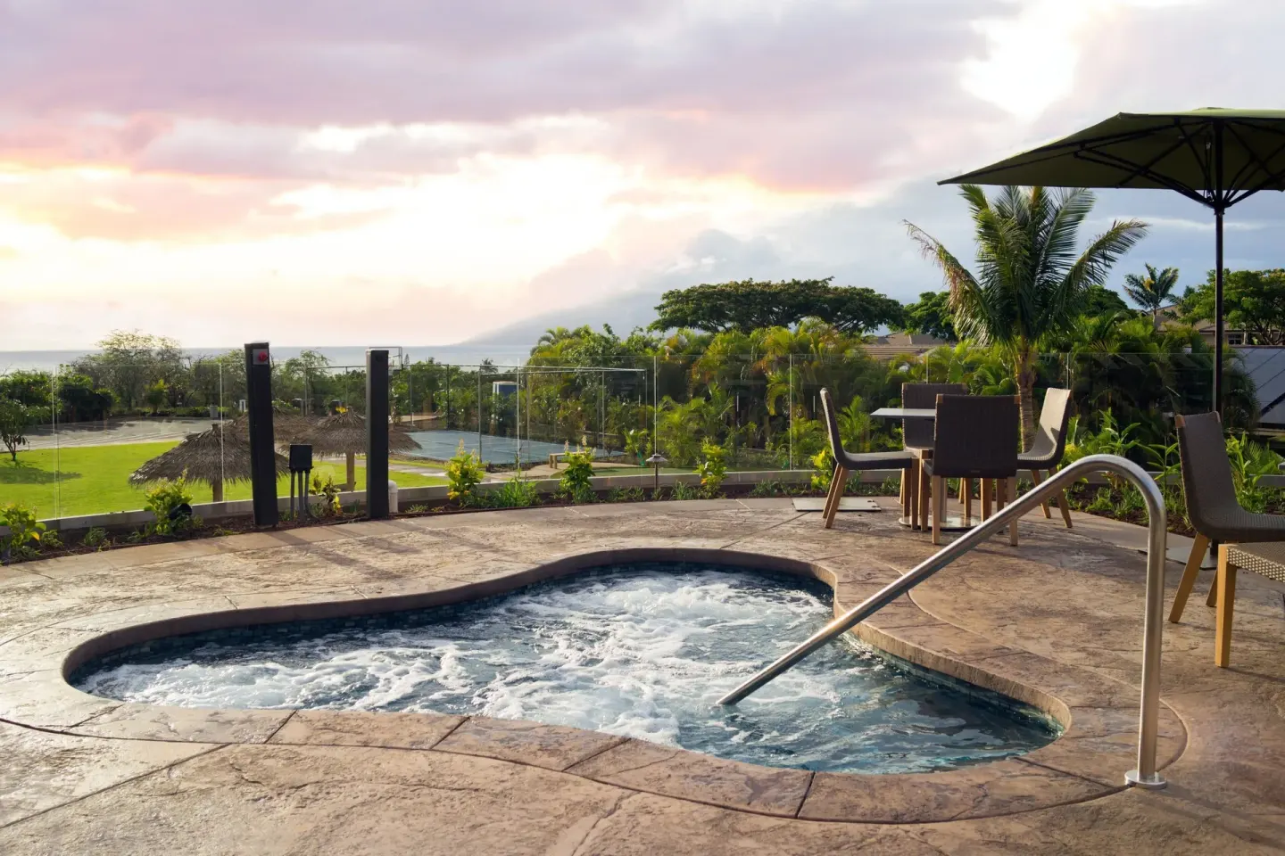 Outdoor whirlpool with patio seating and sunset view at Residence Inn Maui Wailea.