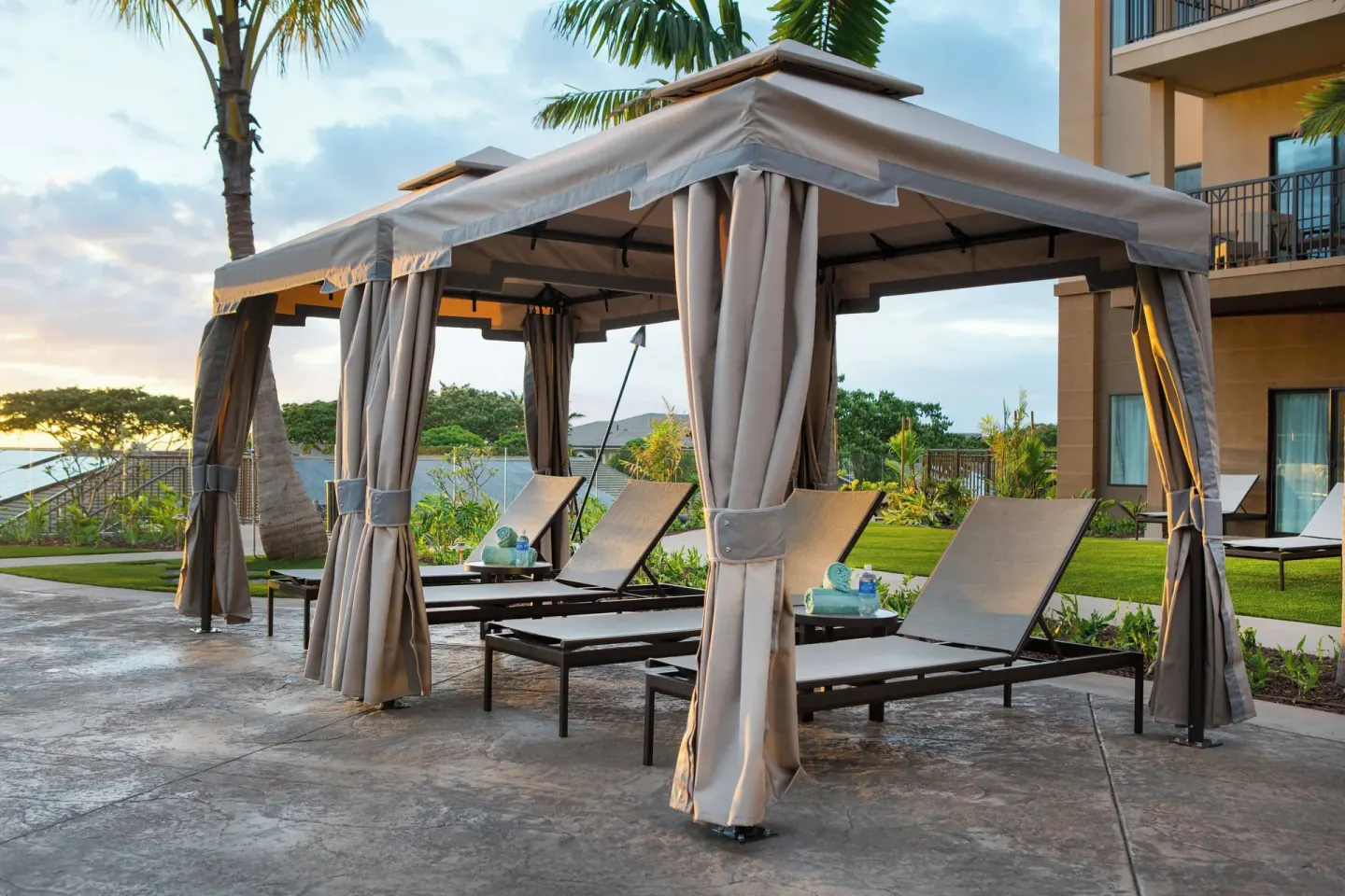 Poolside cabanas with lounge chairs at Residence Inn Maui Wailea.