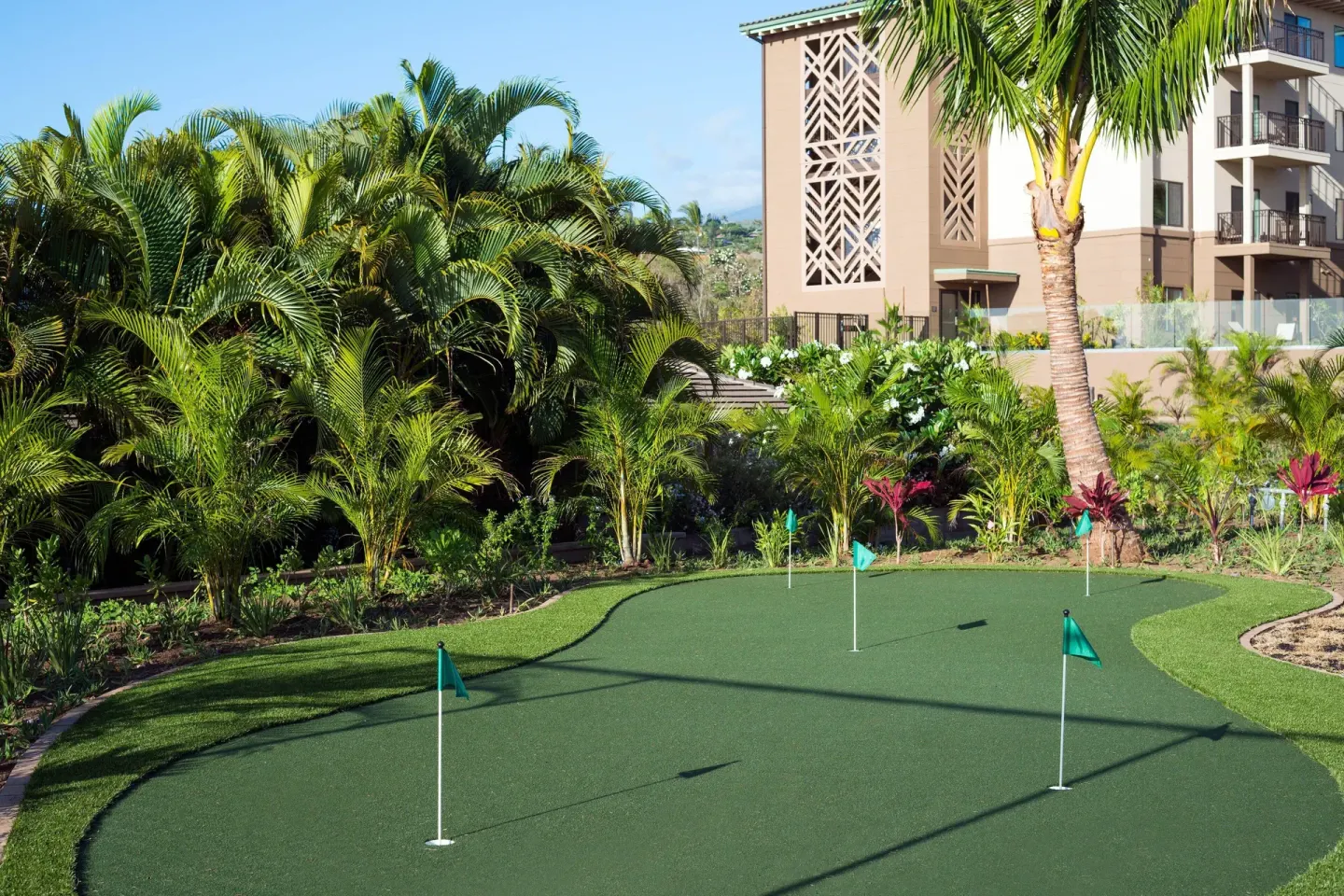 Putting green surrounded by palms at Residence Inn Maui Wailea.