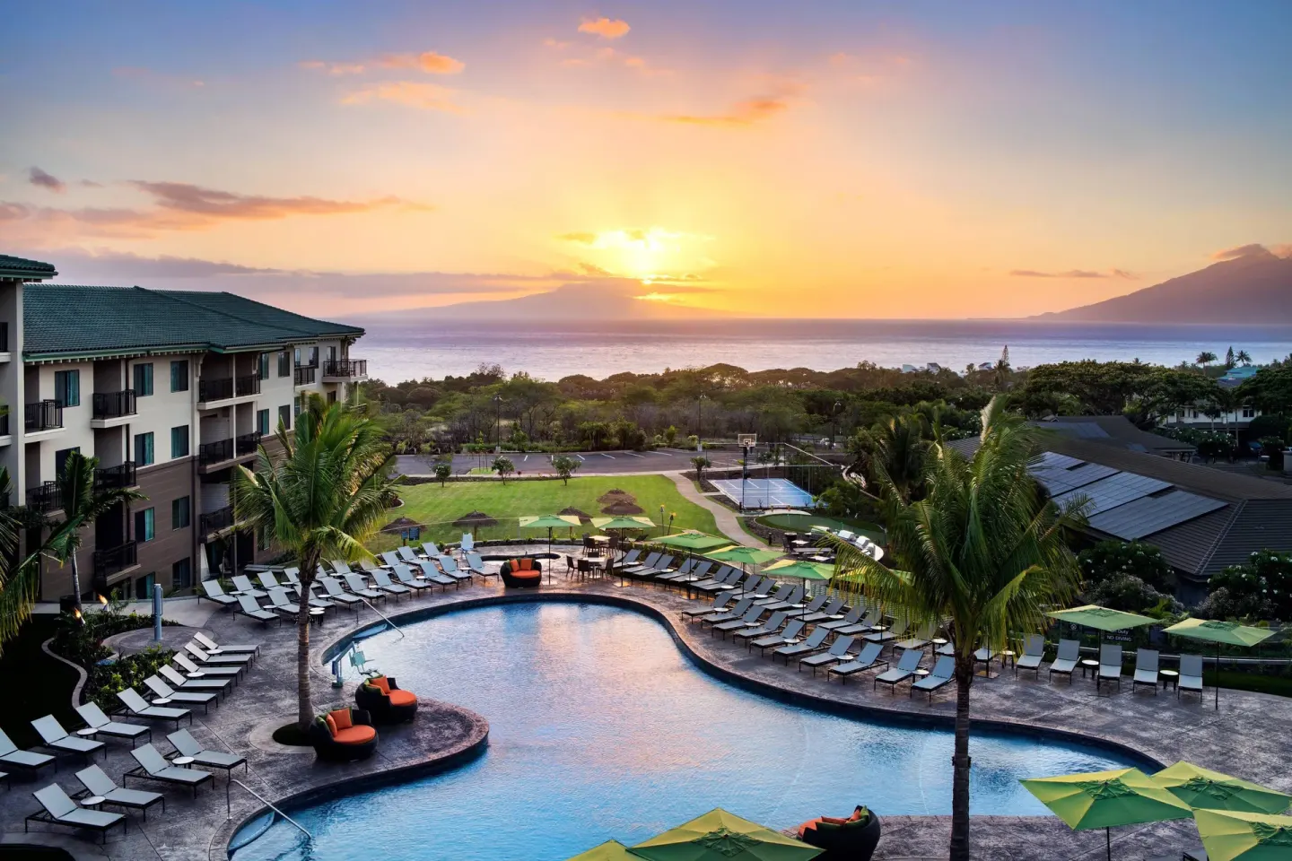 Sunset over the pool and ocean beyond Residence Inn Maui Wailea.