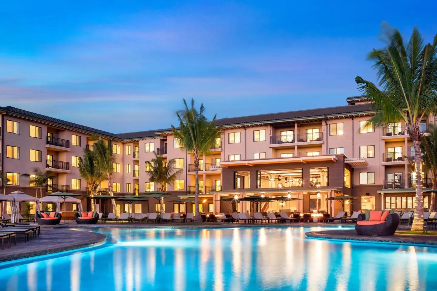 Twilight pool courtyard and guest buildings at Residence Inn Maui Wailea.