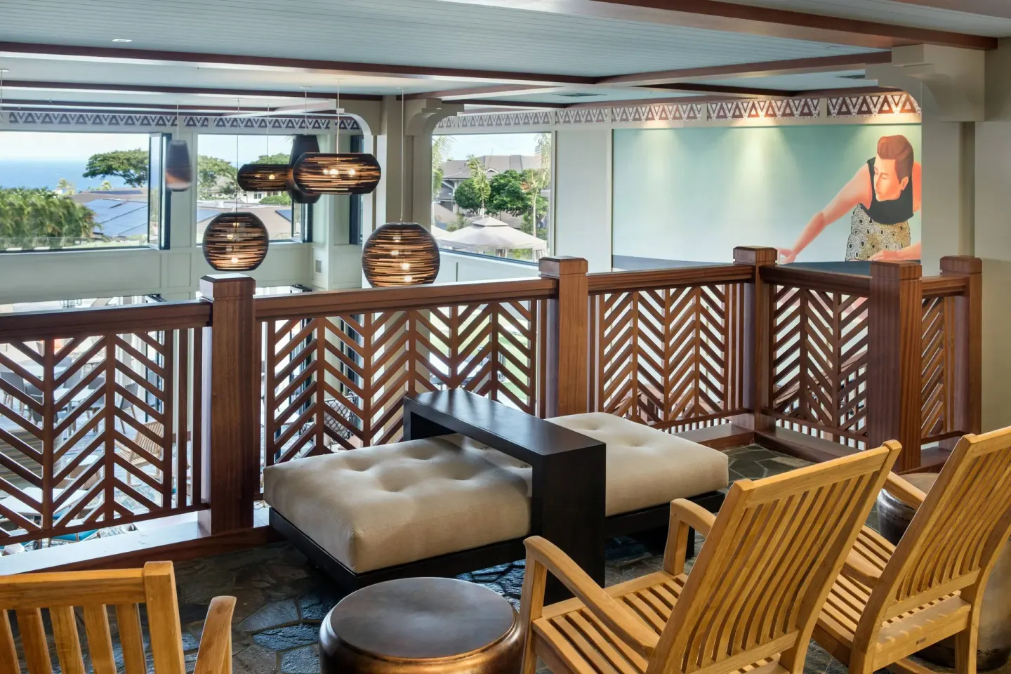 Upper-level lobby seating with wood railing at Residence Inn Maui Wailea.