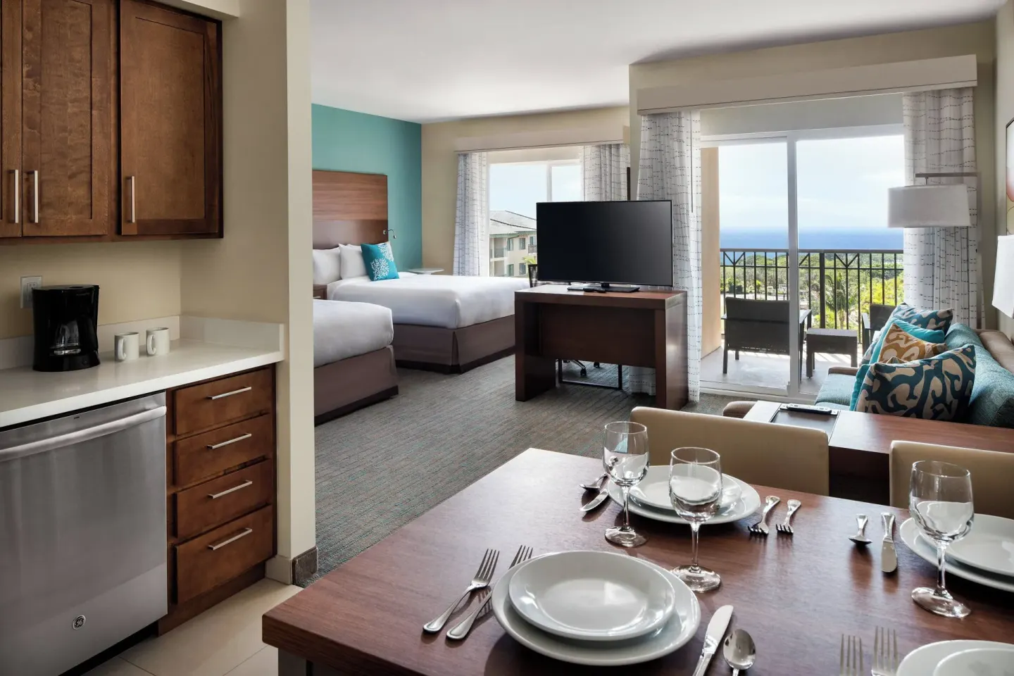 Studio with two beds, kitchen, dining table, and balcony at Residence Inn Maui Wailea.