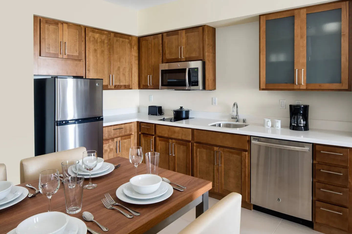 Studio kitchen with dining table and appliances at Residence Inn Maui Wailea.