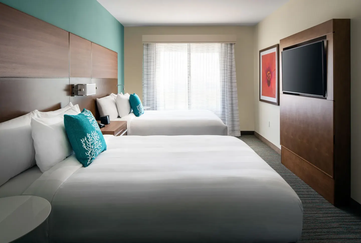 Two-bed bedroom in a suite at Residence Inn Maui Wailea with window and wall-mounted TV.