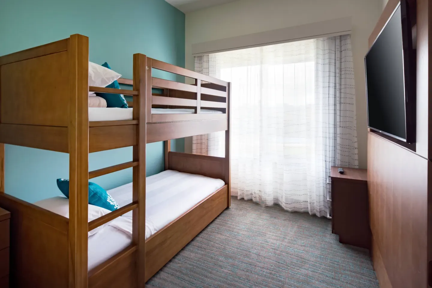 Two-bedroom suite bunk room with wooden bunk beds and a TV at Residence Inn Maui Wailea.