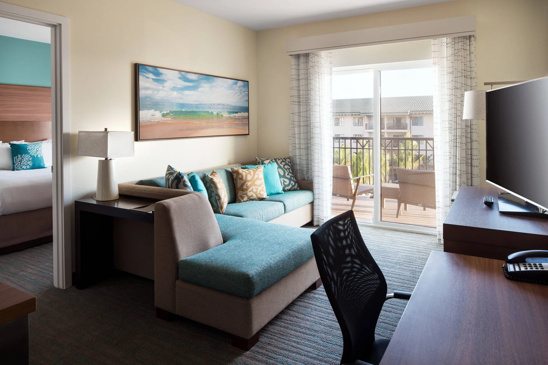 Family Suite Two Bedrooms Ocean View living area at Residence Inn Maui Wailea with modern seating, full kitchen, and Pacific Ocean views in Wailea.