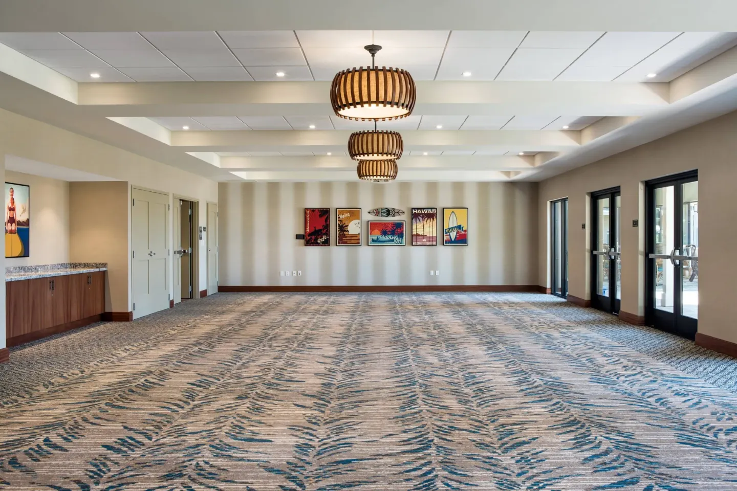 Empty event room with patterned carpet and wall art at Residence Inn Maui Wailea.