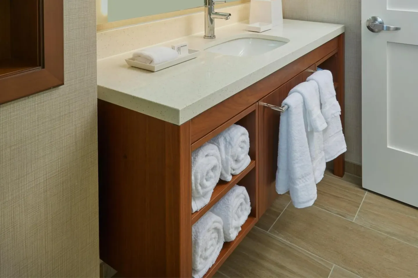 Bathroom vanity with sink, towels, and open shelving at Residence Inn Oahu Kapolei.