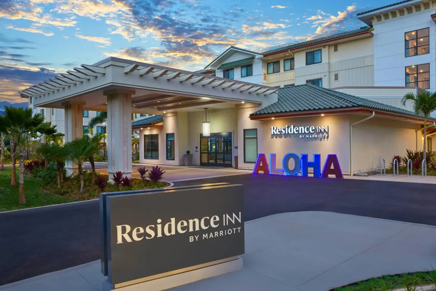 Evening view of the entrance canopy and aloha sign at Residence Inn Oahu Kapolei.