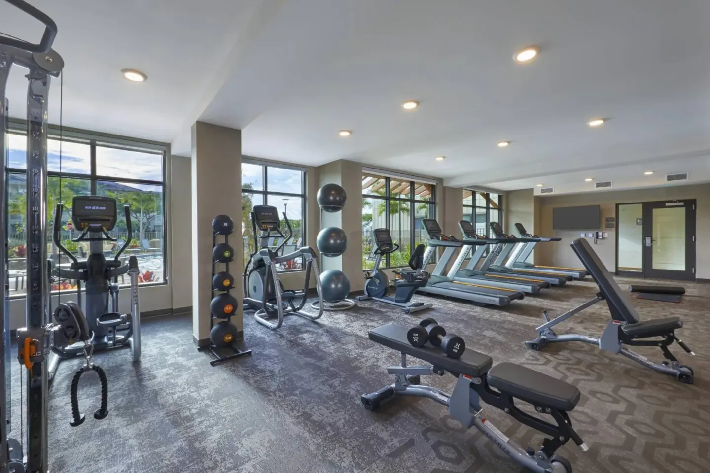 Fitness center with treadmills and weights at Residence Inn Oahu Kapolei.