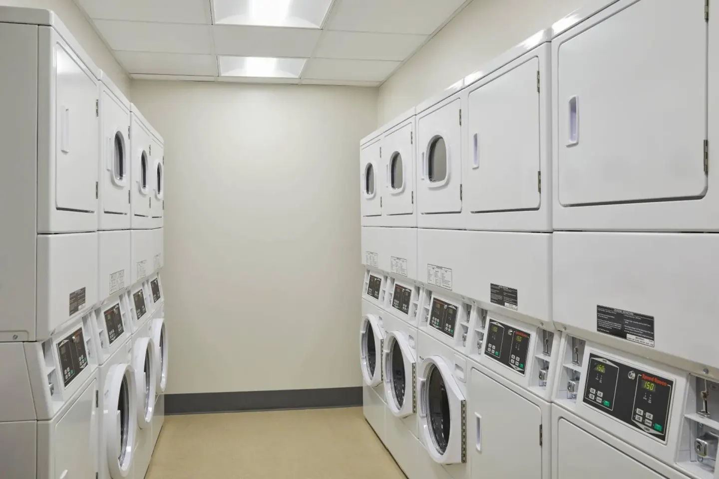 Laundry room with stacked washers and dryers at Residence Inn Oahu Kapolei.