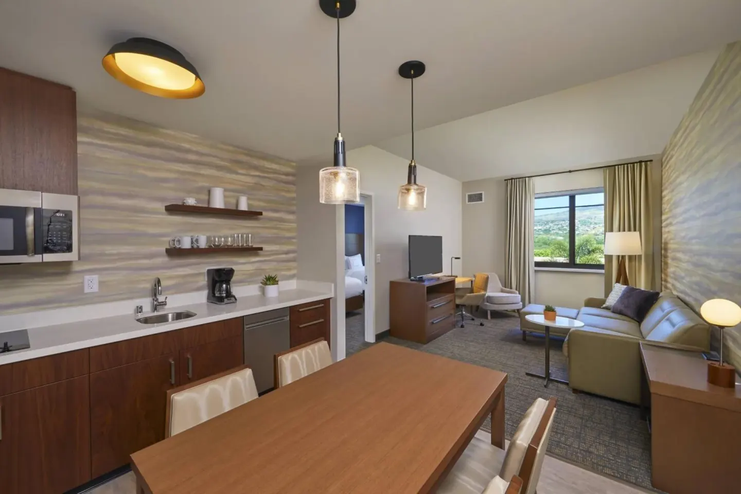 Suite dining table, kitchenette, and living area at Residence Inn Oahu Kapolei.