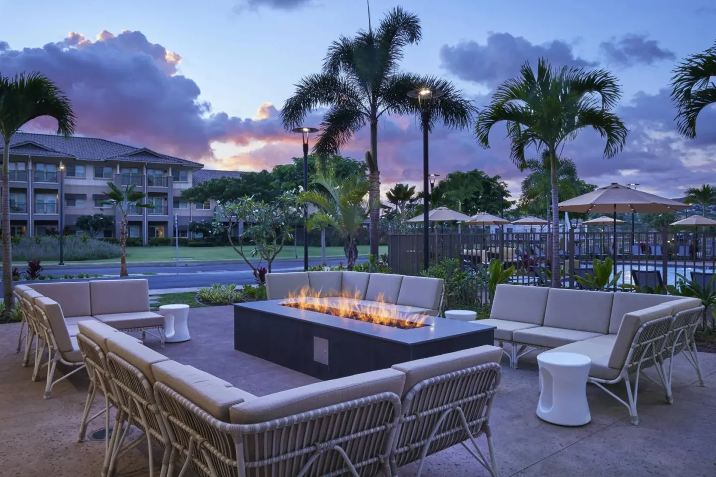Fire pit lounge with cushioned seating at Residence Inn Oahu Kapolei.