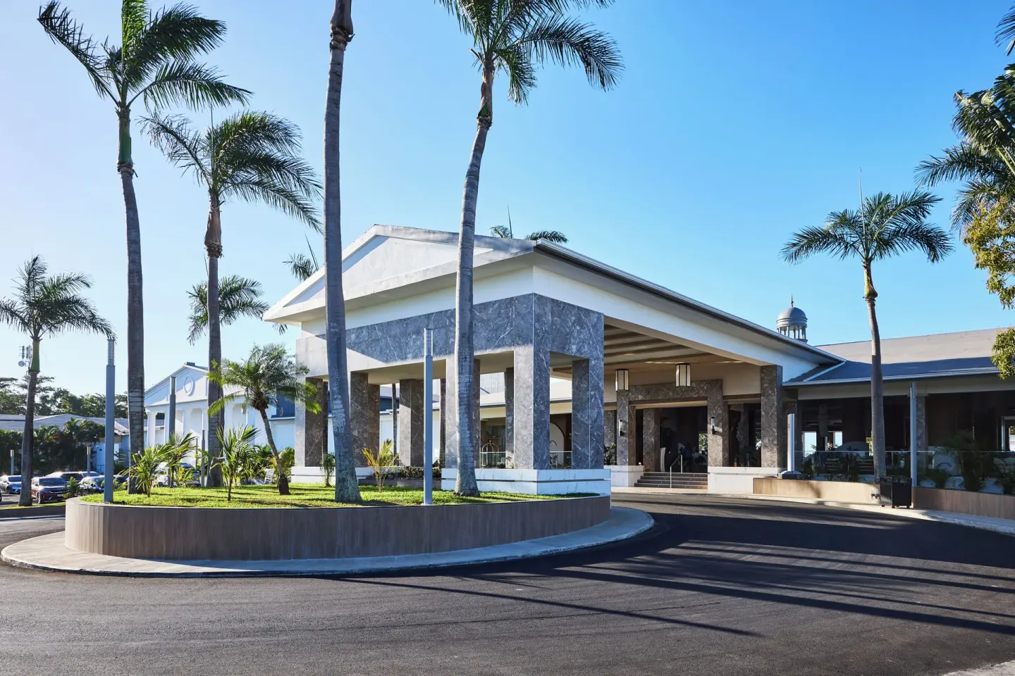 Resort entrance canopy with palm trees and driveway at Riu Negril.