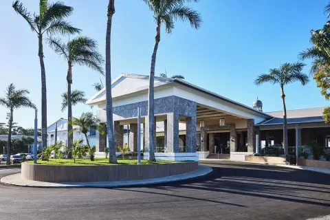 Resort entrance canopy with palm trees and driveway at Riu Negril.