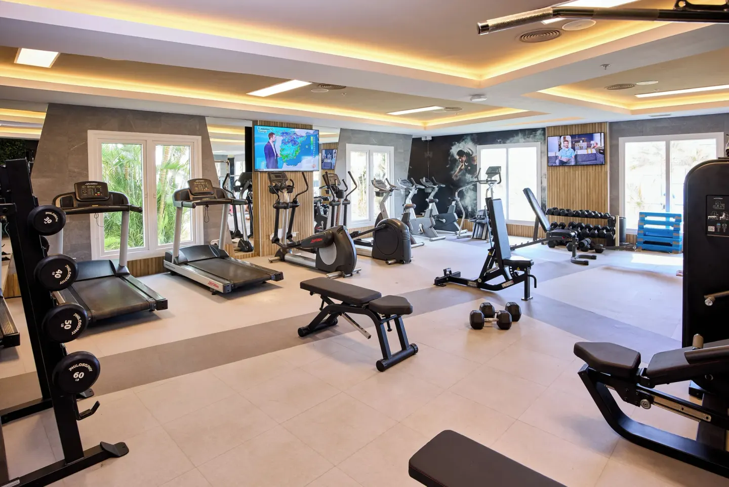 Fitness center with treadmills, bikes, weights, and benches at Riu Negril.