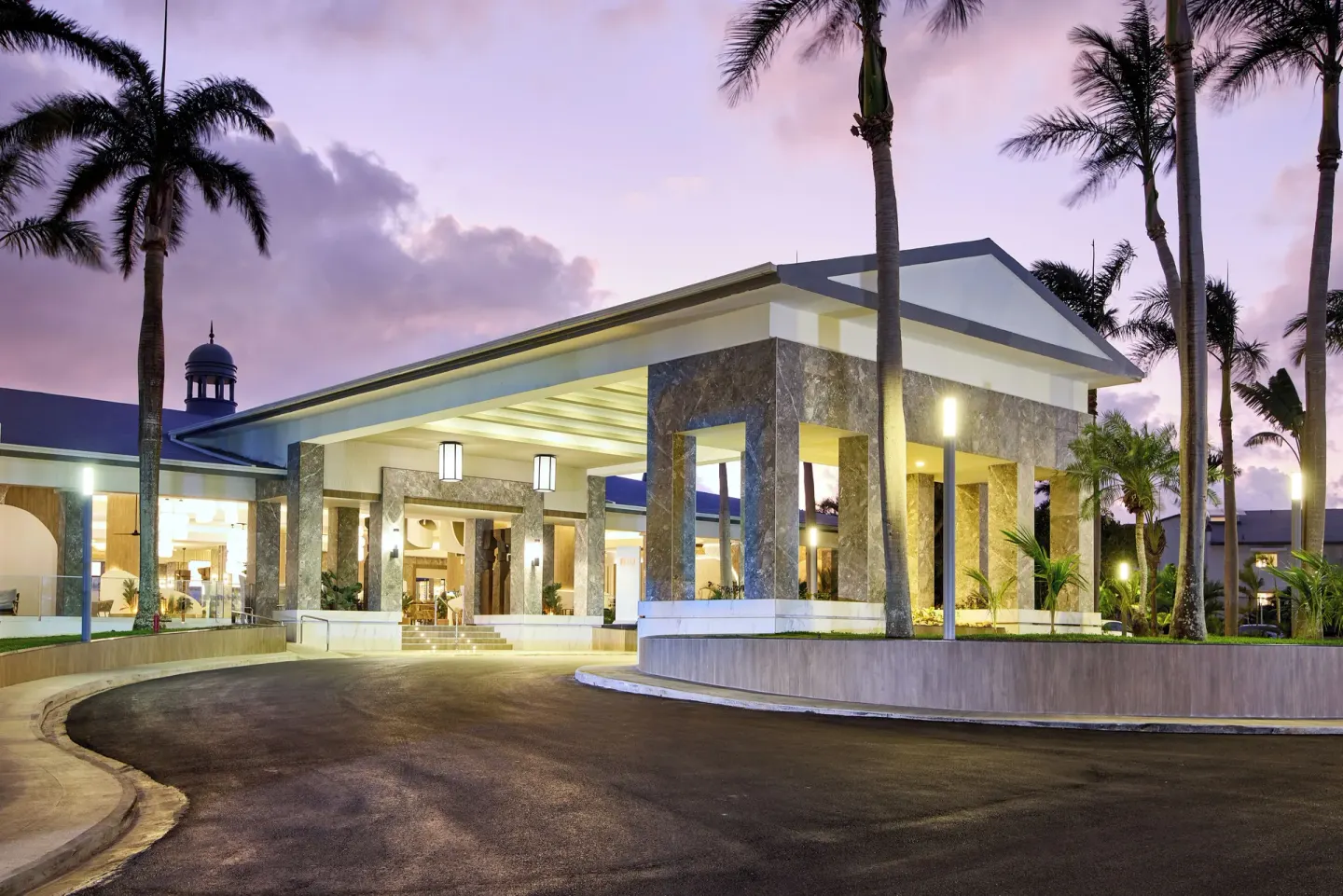 Illuminated entrance canopy and driveway at dusk at Riu Negril.