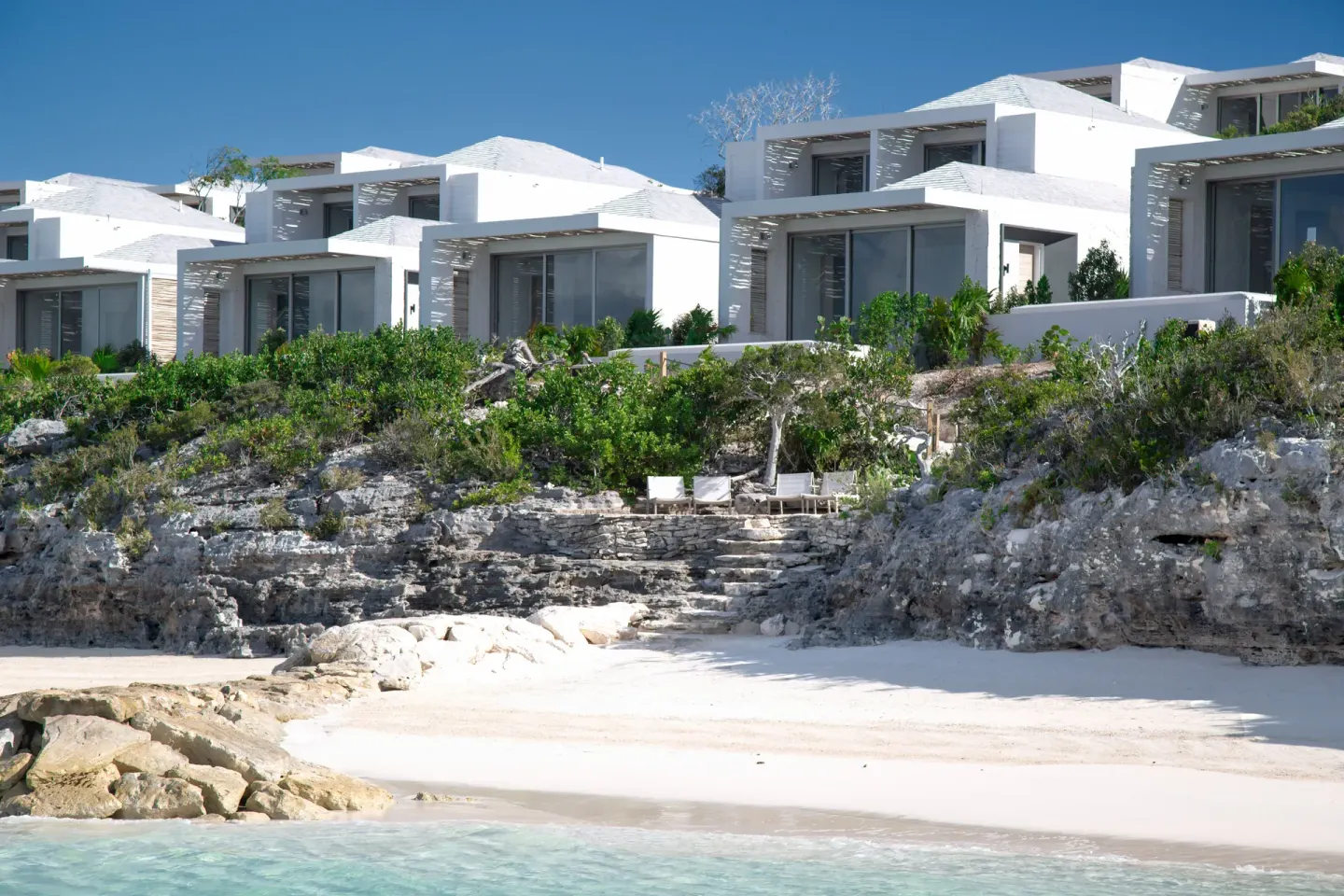 Cliffside villas above a small sandy beach at Rock House.