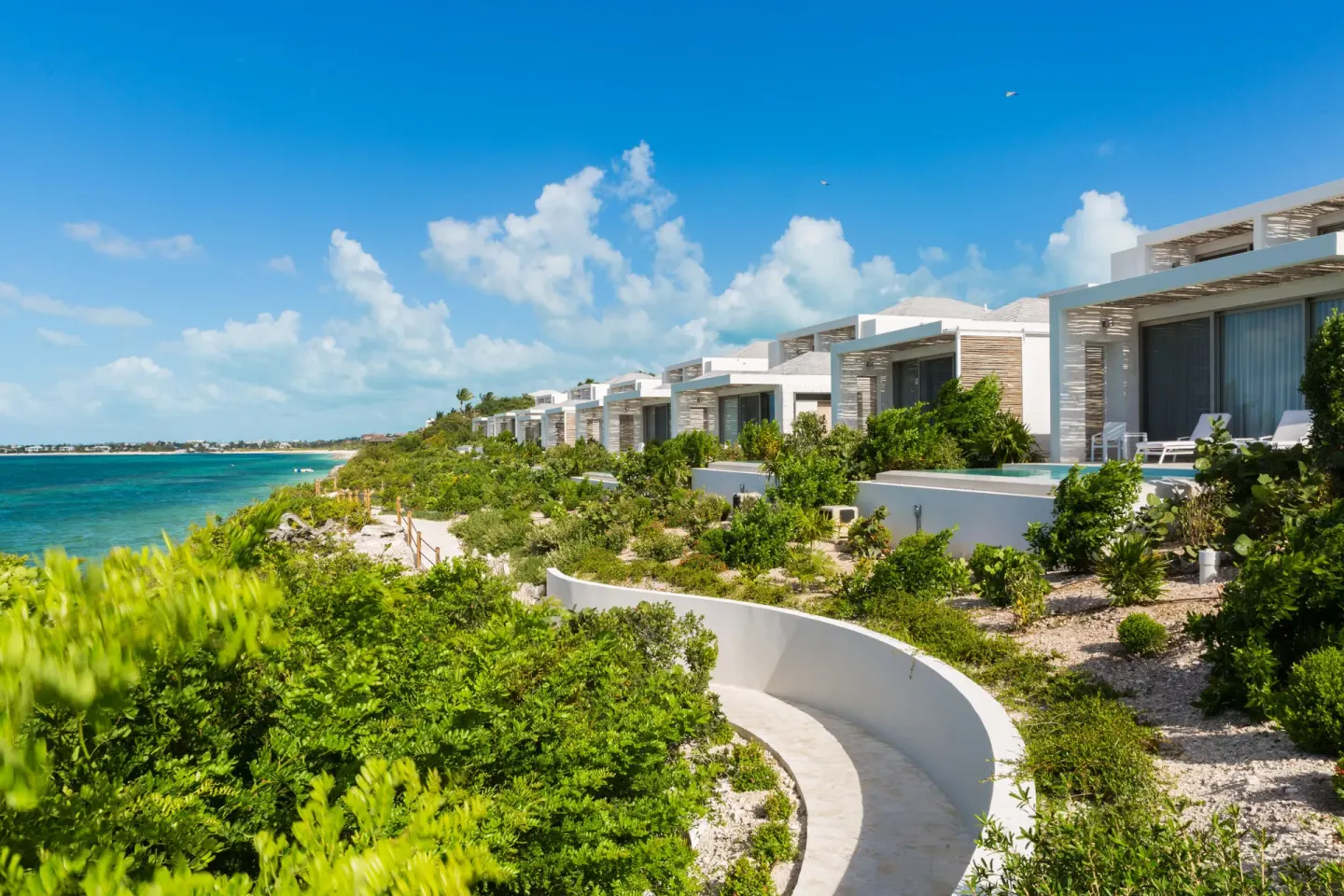 Garden path and white villas along the oceanfront at Rock House.