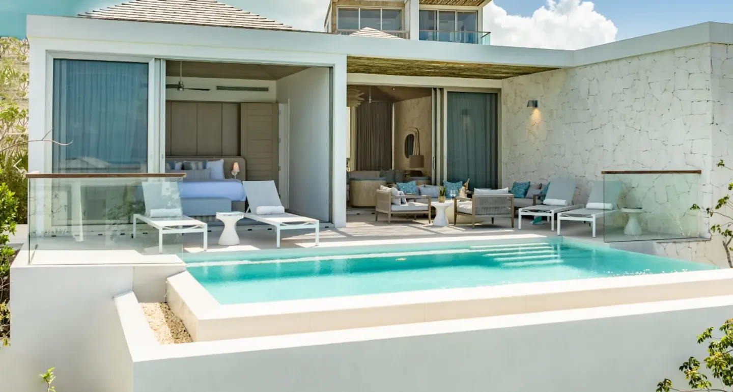 Private pool terrace and bedroom at Rock House with lounge seating and white stone walls.