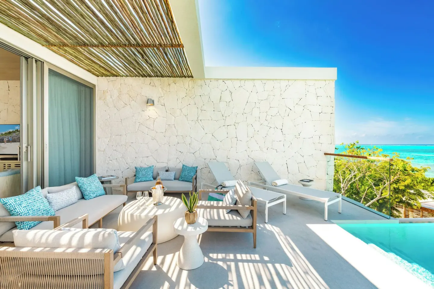 Terrace seating, loungers and plunge pool with ocean view at Rock House.