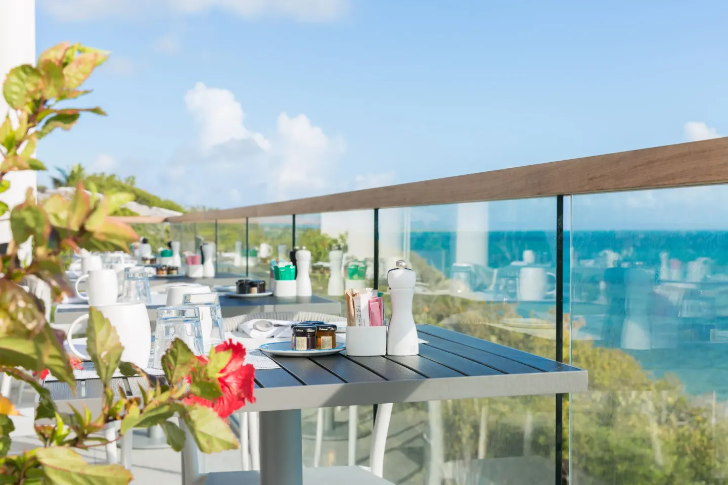Outdoor terrace table set with condiments and ocean views at Rock House.