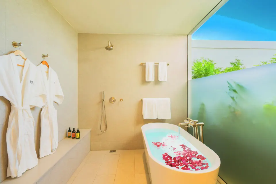 Oceanfront One Bedroom bathroom with soaking tub and outdoor shower at Rock House.