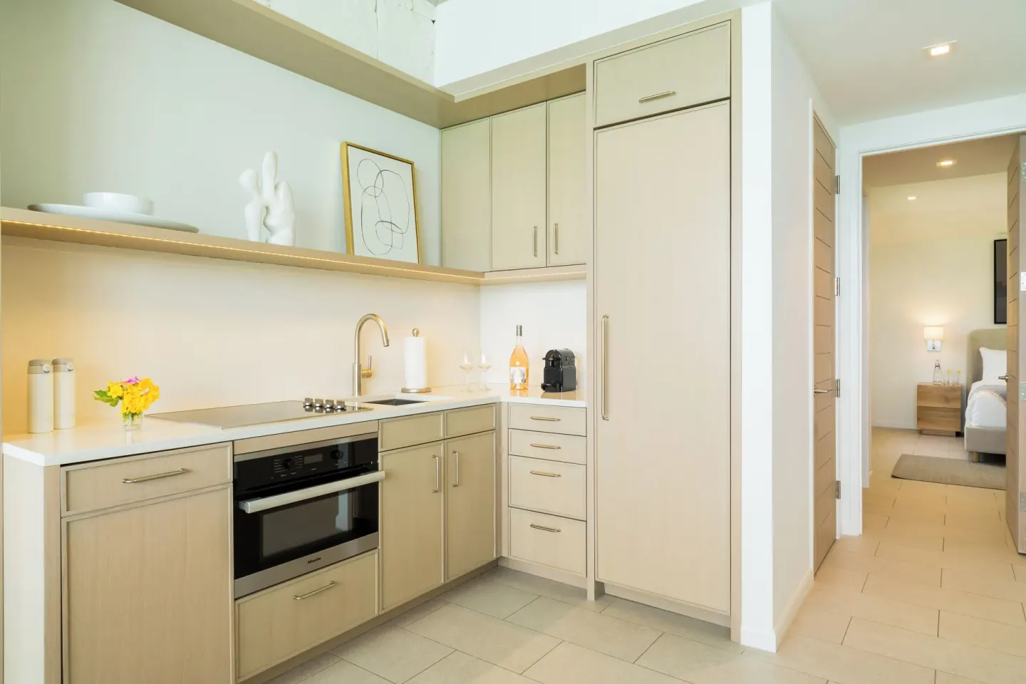 Oceanfront One Bedroom kitchenette with bedroom beyond at Rock House.