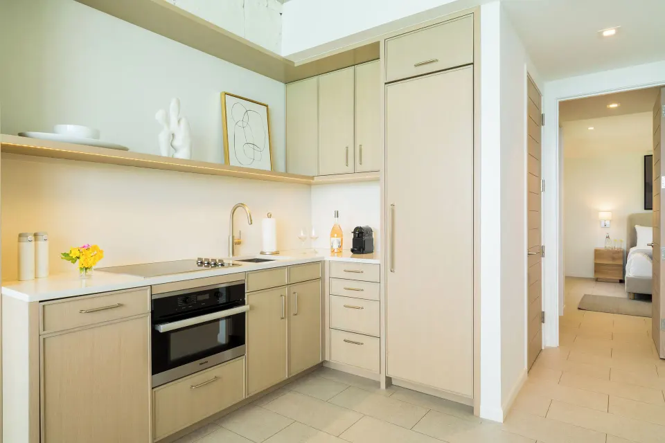 Oceanfront One Bedroom kitchenette with bedroom beyond at Rock House.