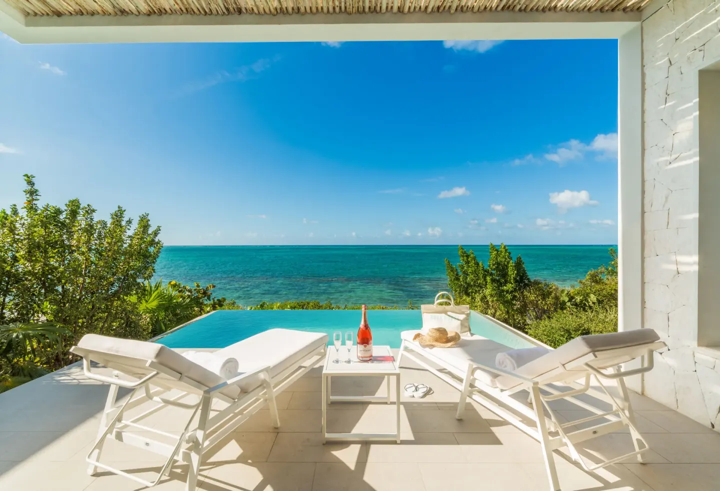 Oceanfront One Bedroom terrace with loungers and plunge pool at Rock House.