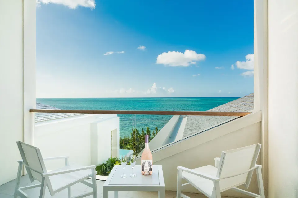 Oceanfront Studio balcony with chairs and ocean view at Rock House.
