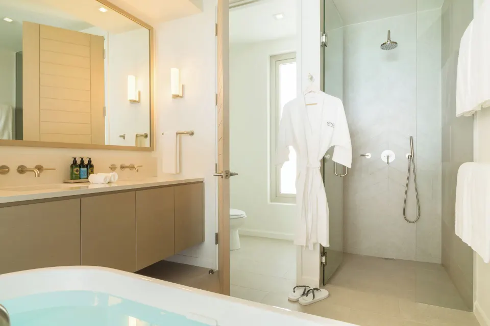 Oceanfront Studio bathroom shower, tub edge and vanity at Rock House.