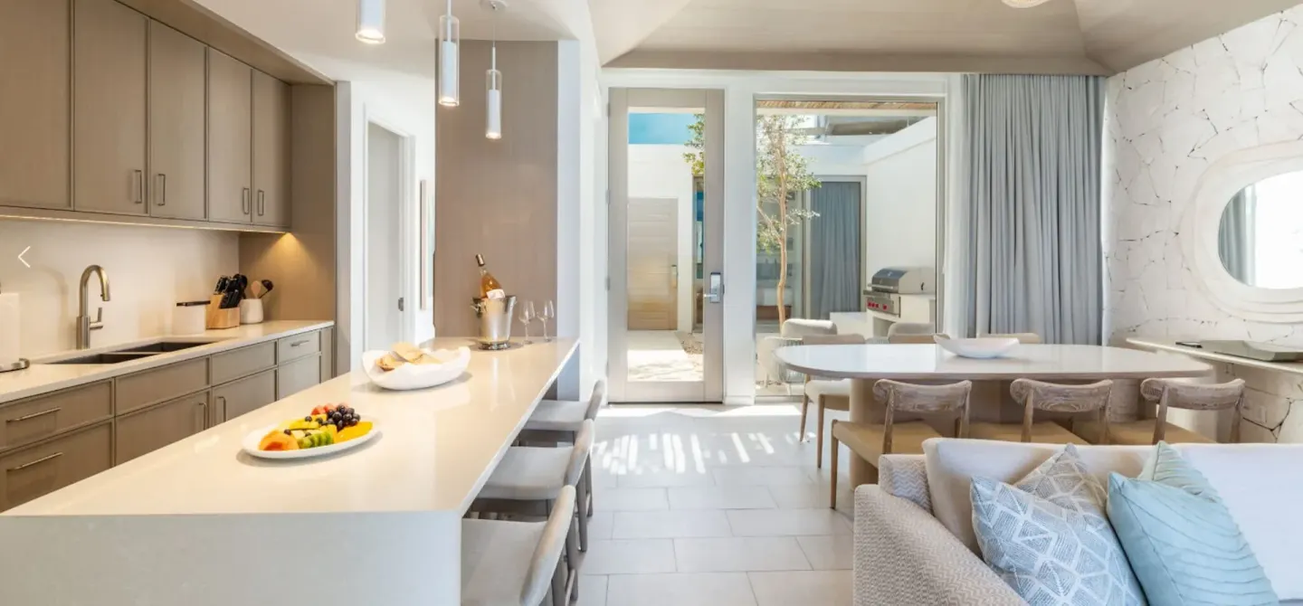 Villa 2-bedroom ocean view open living and kitchen space at Rock House leading to a private patio.