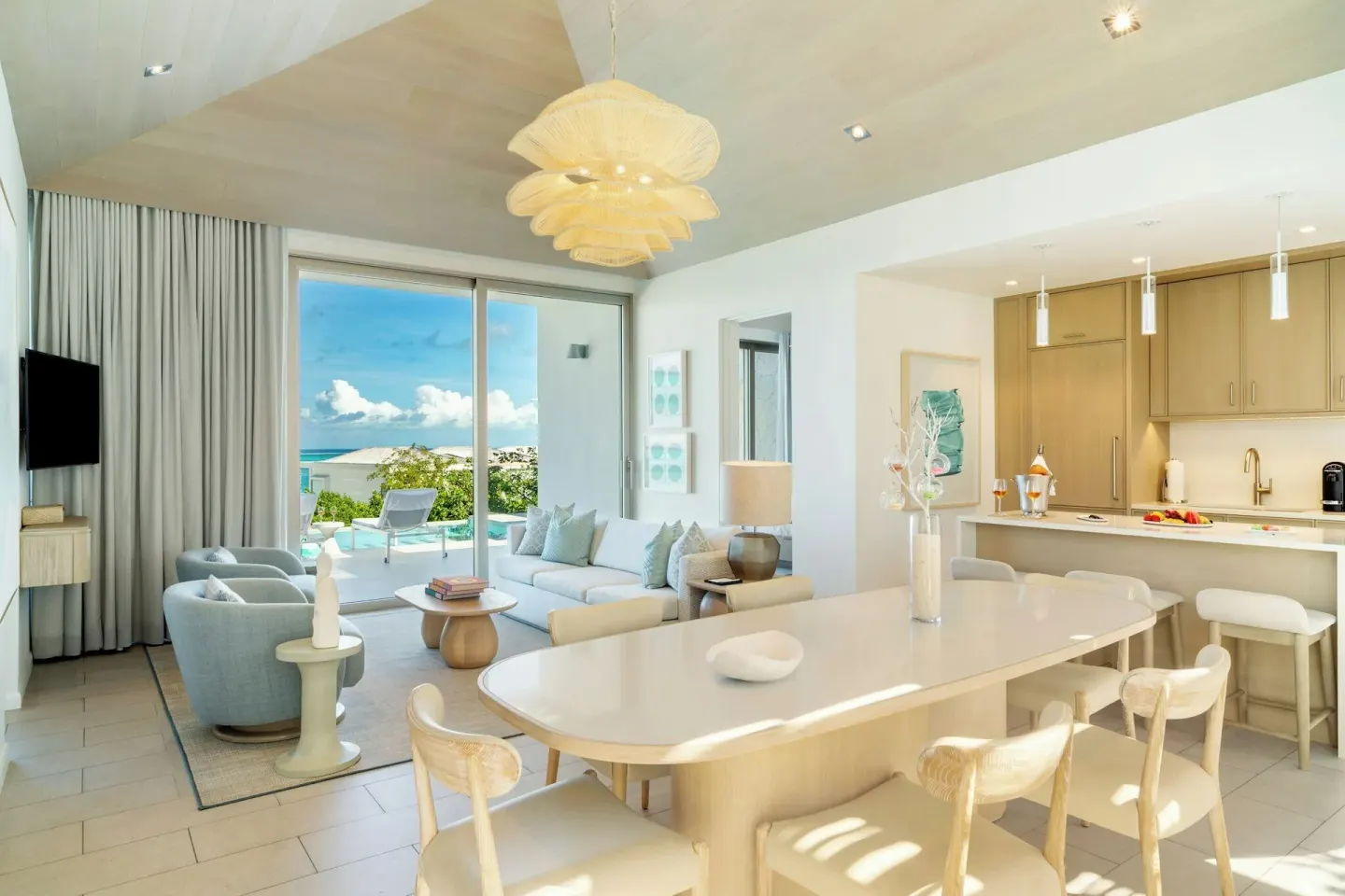 Ocean-view villa living room, dining table, kitchen, and terrace at Rock House.