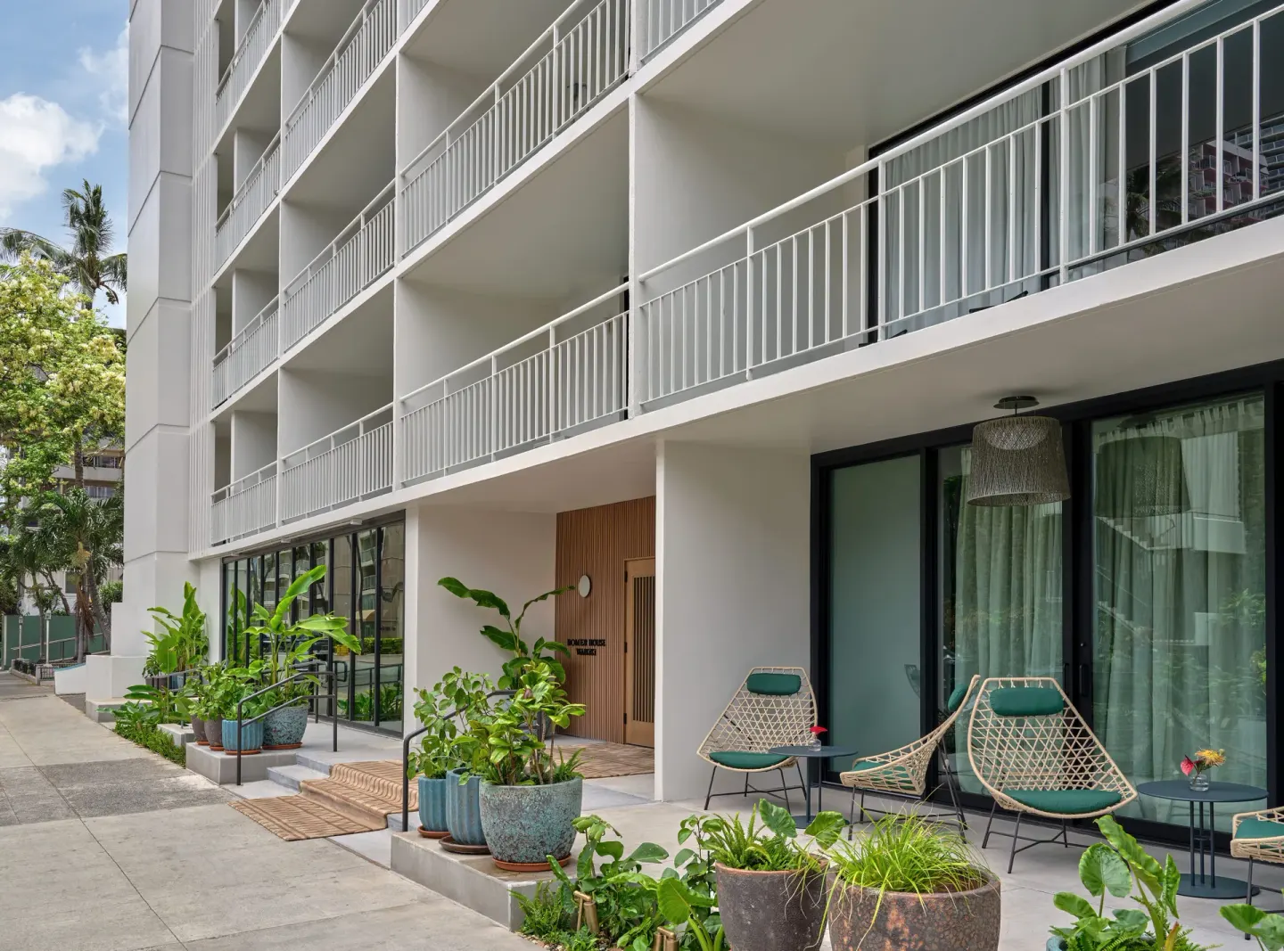Exterior balconies and patio seating at Romer House Waikiki.