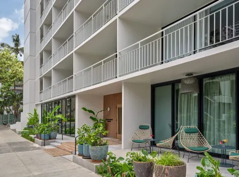 Exterior balconies and patio seating at Romer House Waikiki.