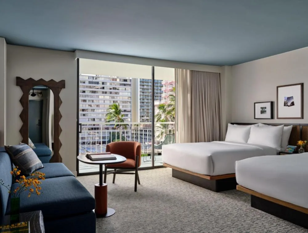 Junior Suite with two queen beds, sofa bed, and balcony at Romer House Waikiki.