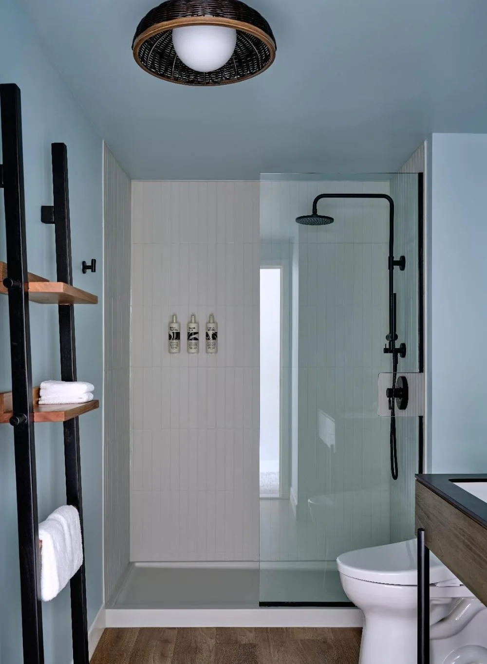 Premium room bathroom with glass shower at Romer House Waikiki.