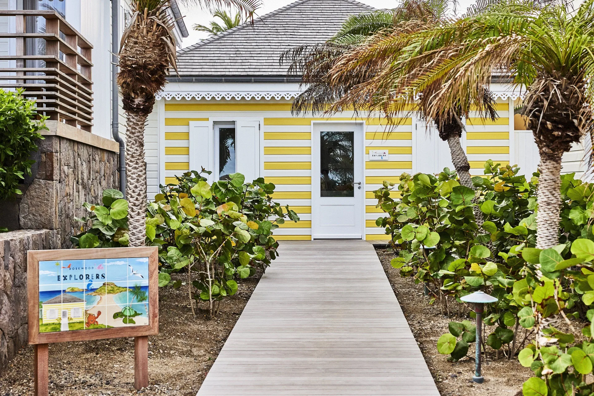 Yellow-and-white explorers building entrance at Rosewood Le Guanahani St Barth.