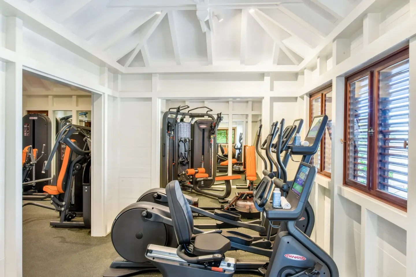 Cardio and weight machines fill a bright fitness room at Rosewood Le Guanahani St Barth.