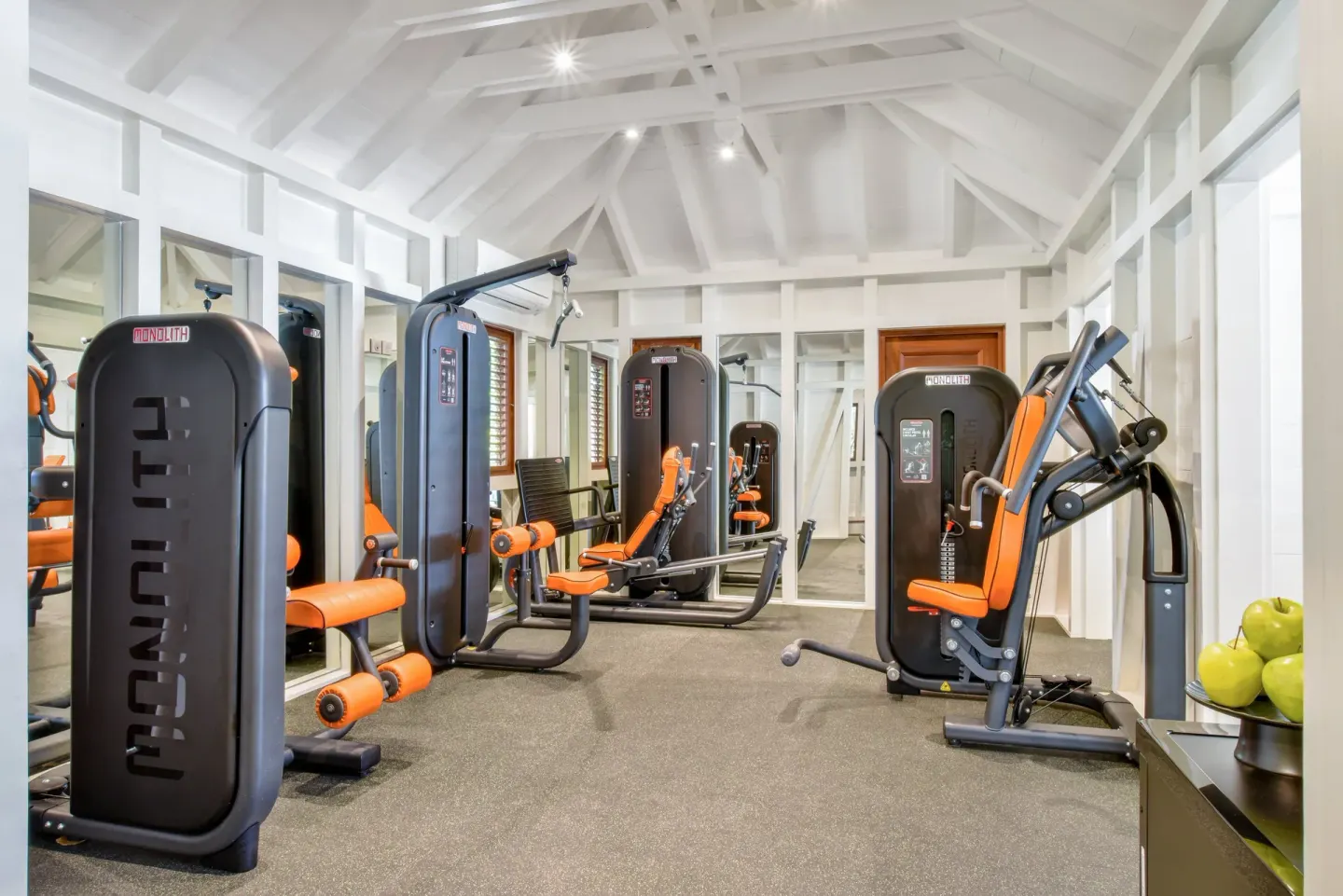 Fitness room with strength machines and mirrors at Rosewood Le Guanahani St Barth.