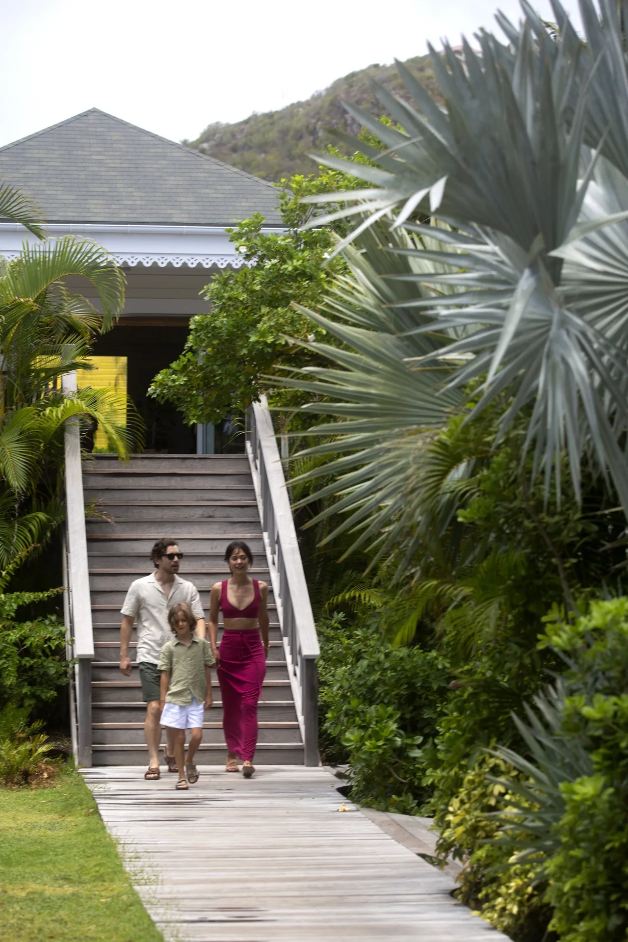 Guests walking down garden steps beside tropical plants at Rosewood Le Guanahani St Barth.