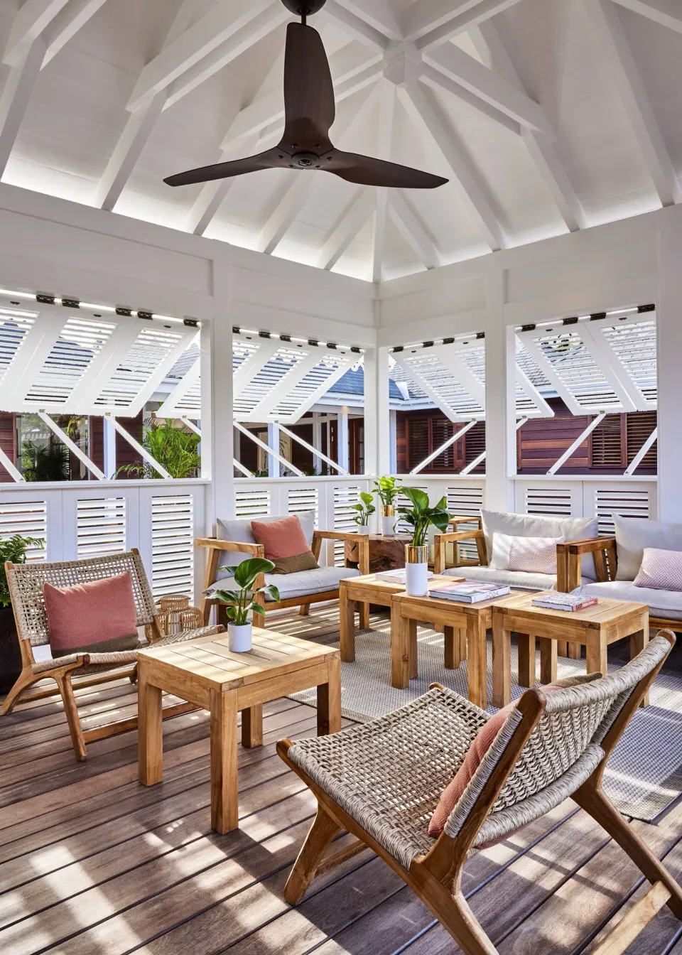 Open-air lounge pavilion with wood seating at Rosewood Le Guanahani St Barth.