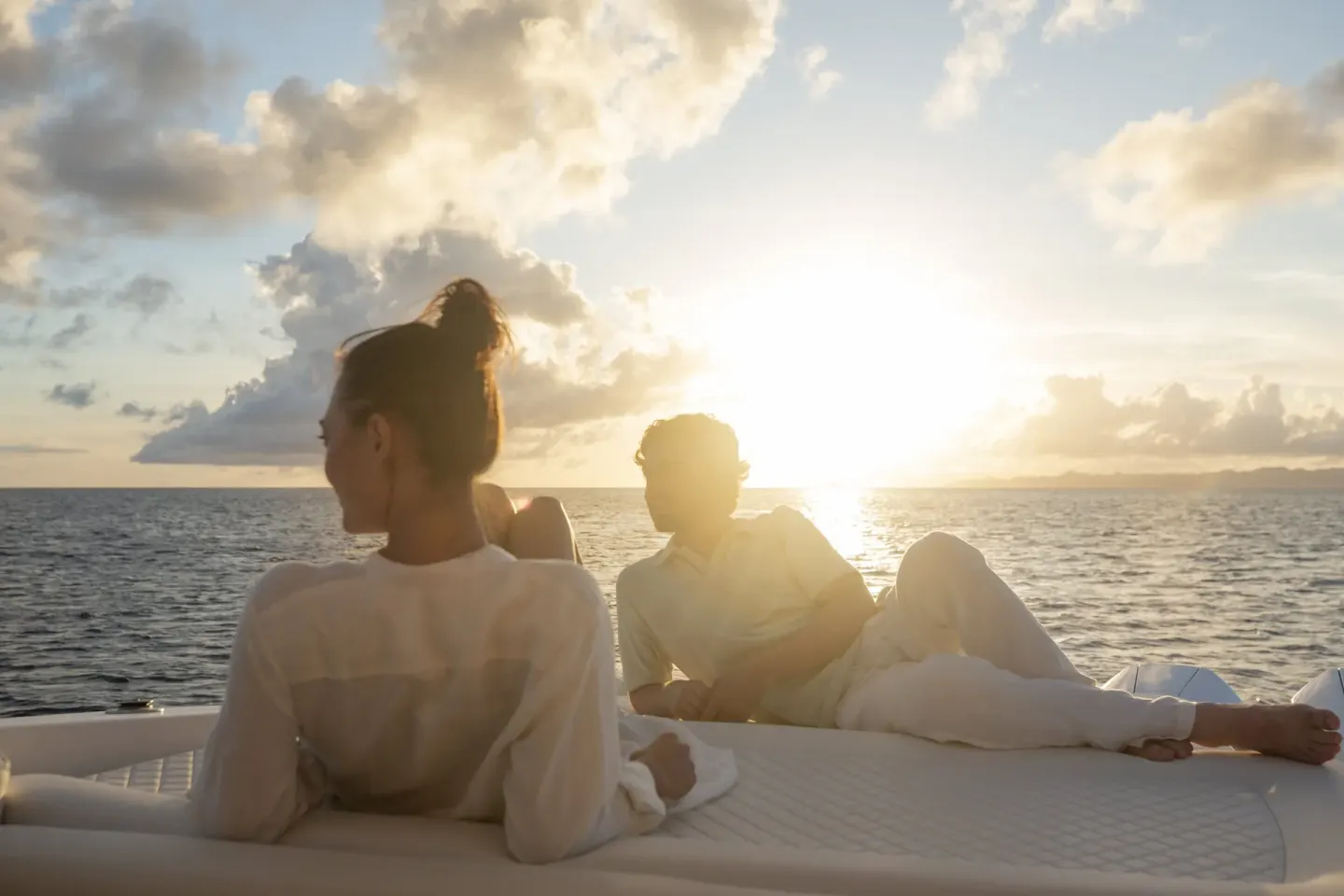 Guests relax on a boat at sunset near Rosewood Le Guanahani St Barth.
