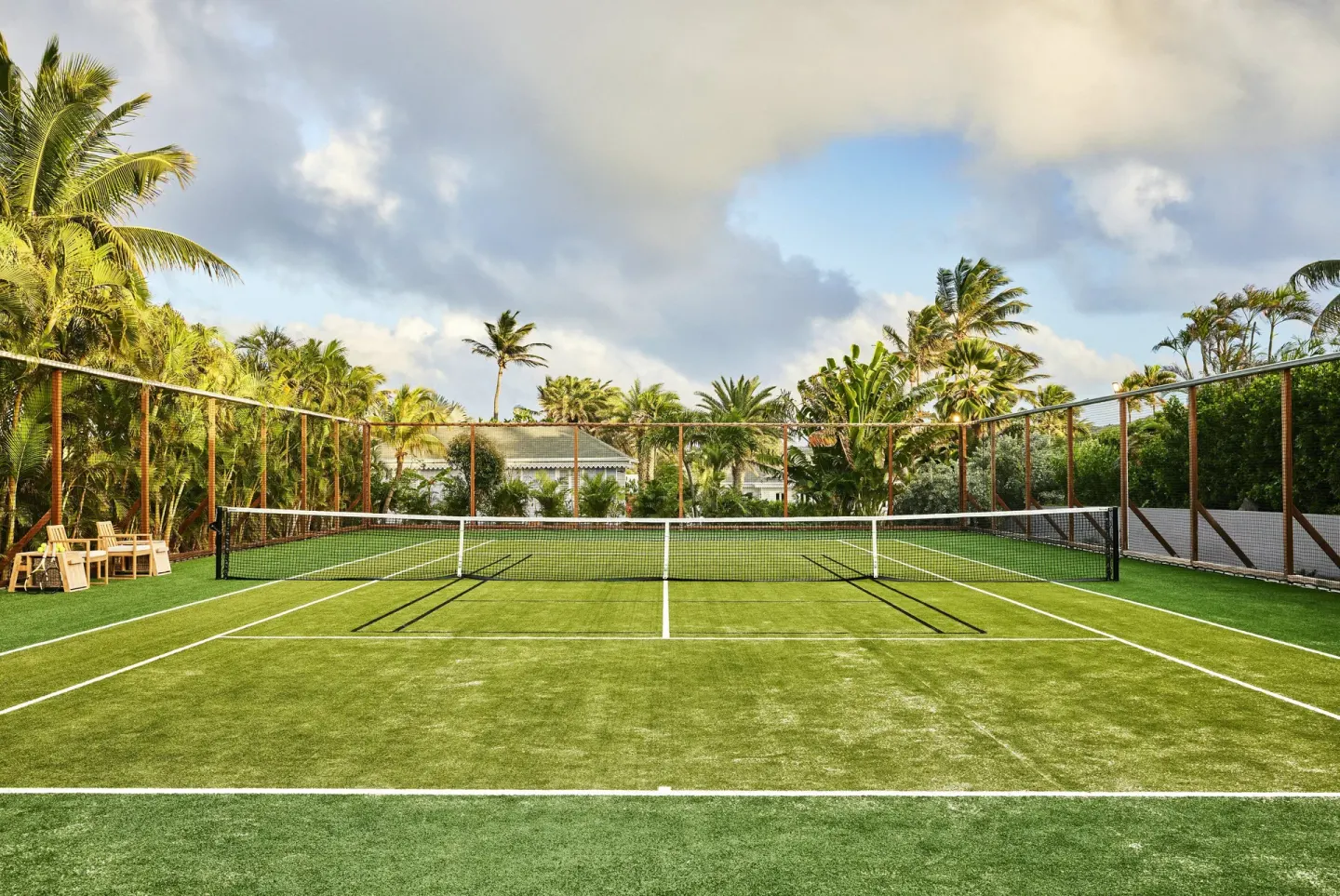 Tennis court surrounded by palms at Rosewood Le Guanahani St Barth.