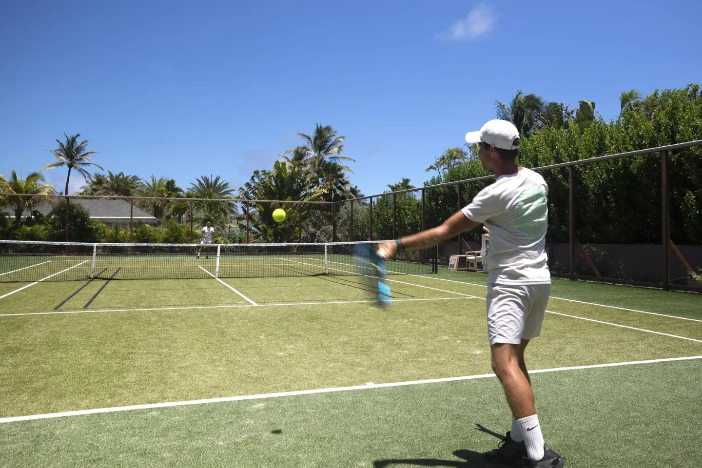 Guests playing tennis on the court at Rosewood Le Guanahani St Barth.