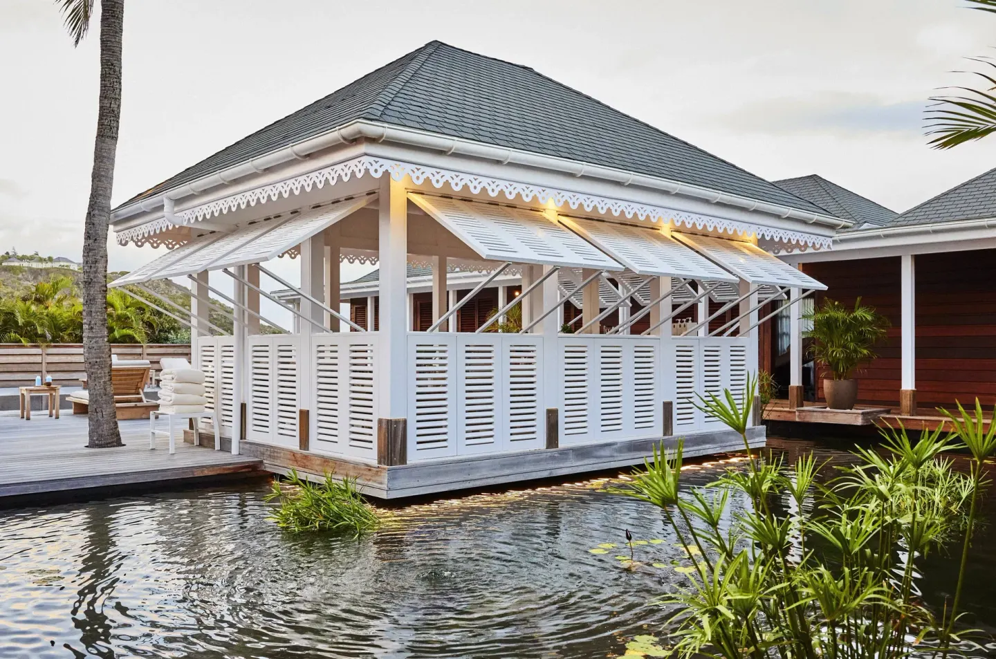 White pavilion over water in the resort grounds at Rosewood Le Guanahani St Barth.