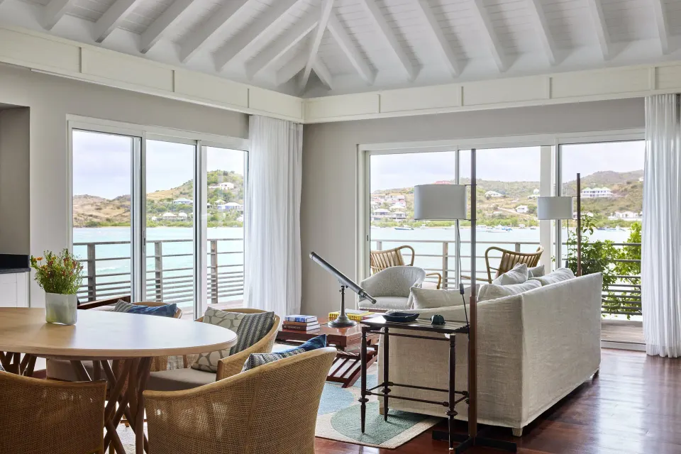 Admiral Suite living and dining room with balcony views at Rosewood Le Guanahani St Barth.